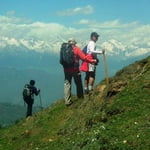 Traversing the Meadows of Kuppar mirrored by snow - capped Himalaya! 
