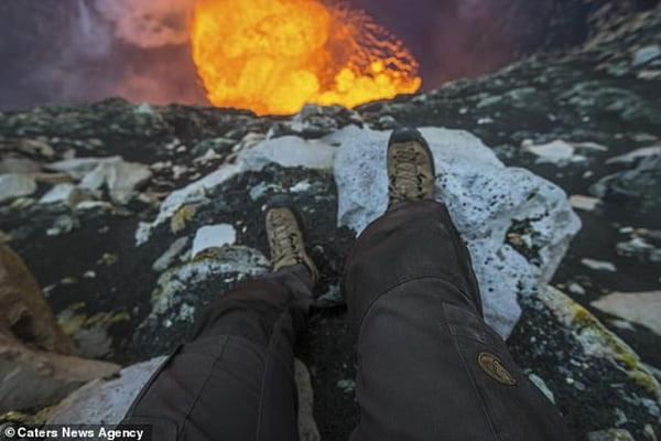 Daredevil adventure-seeker abseils into active volcano with molten lava before doing a handstand on the edge