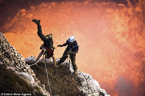 Daredevil adventure-seeker abseils into active volcano with molten lava before doing a handstand on the edge